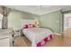 Bedroom with light green walls, light hardwood floors, and lots of natural lighting at 1129 Gavinwood Pl, Decatur, GA 30033