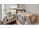 This grey bedroom has a desk and chair set, and a bed with a quilted bedspread at 1129 Gavinwood Pl, Decatur, GA 30033