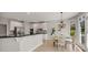Bright kitchen with white cabinetry, stainless steel appliances, granite countertops and an adjacent breakfast nook at 1129 Gavinwood Pl, Decatur, GA 30033