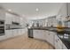 Modern kitchen features white cabinets, granite countertops, stainless steel appliances, and eat-in breakfast area at 1129 Gavinwood Pl, Decatur, GA 30033