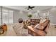 Bright living room boasts hardwood floors, a leather sectional sofa, plantation shutters, and neutral walls at 1129 Gavinwood Pl, Decatur, GA 30033