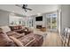 Cozy living area featuring a fireplace, large windows, hardwood floors, and a leather sectional at 1129 Gavinwood Pl, Decatur, GA 30033