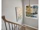 A staircase with an ornate chandelier and a view of a window to the outside at 1129 Gavinwood Pl, Decatur, GA 30033