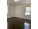 A sunny bedroom with a hardwood floor and two windows brings in natural light at 1649 Ezra Church Nw Dr, Atlanta, GA 30314