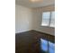 A sunny bedroom with a hardwood floor and two windows brings in natural light at 1649 Ezra Church Nw Dr, Atlanta, GA 30314