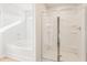 This bathroom features a tub and separate shower with glass doors at 5527 Rosehall Pl, Atlanta, GA 30349