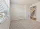 Cozy bedroom with a large window bringing in natural light and plush carpeting at 5527 Rosehall Pl, Atlanta, GA 30349