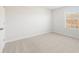 Relaxing bedroom featuring neutral carpet, natural light, and a spacious feel at 5527 Rosehall Pl, Atlanta, GA 30349