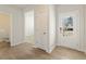 Inviting foyer with wood-look floors, a view into the living area, and a door with a glass pane at 5527 Rosehall Pl, Atlanta, GA 30349