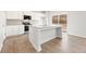 Contemporary kitchen featuring an island with seating, granite countertops, and stainless steel appliances at 5527 Rosehall Pl, Atlanta, GA 30349