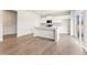 Modern kitchen with an island, stainless steel appliances, white cabinets, and luxury vinyl plank flooring at 5527 Rosehall Pl, Atlanta, GA 30349