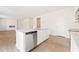 Gourmet kitchen boasts granite counters, stainless appliances, and a view to the fireplace at 5527 Rosehall Pl, Atlanta, GA 30349