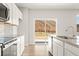 Well-lit kitchen featuring stainless appliances, granite countertops, and sliding glass doors at 5527 Rosehall Pl, Atlanta, GA 30349