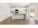 A bright, open kitchen features stainless appliances, white cabinets, and a large island at 5527 Rosehall Pl, Atlanta, GA 30349