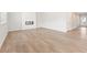 Spacious living room with a contemporary fireplace, light wood floors, and ample space for entertaining at 5527 Rosehall Pl, Atlanta, GA 30349
