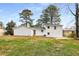 Exterior view of the home showcasing a sprawling backyard with lush greenery and mature trees at 151 Wilbur Ln, Lawrenceville, GA 30044