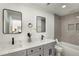 Modern bathroom with double vanity, sleek mirrors, updated tile, and a separate bathtub at 151 Wilbur Ln, Lawrenceville, GA 30044