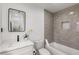 This bathroom features a tub, toilet, and a vanity with marble countertops and a black faucet at 151 Wilbur Ln, Lawrenceville, GA 30044