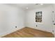 This bedroom features hardwood floors, a window, white walls and trim, and great natural light at 151 Wilbur Ln, Lawrenceville, GA 30044