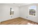 This bedroom features hardwood floors, two windows, white walls and trim, and great natural light at 151 Wilbur Ln, Lawrenceville, GA 30044