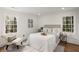 The bedroom features hardwood floors, two windows, an area rug, and a bed with decorative pillows at 151 Wilbur Ln, Lawrenceville, GA 30044