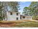 View of a charming home with a brick and siding exterior, set on a lot with mature trees and partial lawn at 151 Wilbur Ln, Lawrenceville, GA 30044