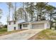 Attractive home with a white brick and siding exterior, featuring an attached two-car garage and a concrete driveway at 151 Wilbur Ln, Lawrenceville, GA 30044