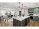 Open kitchen featuring a large island, modern lighting, stainless appliances, and stylish green cabinetry at 151 Wilbur Ln, Lawrenceville, GA 30044