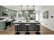 Well-appointed kitchen featuring shaker cabinets, an island with seating, pendant lights, and stainless steel appliances at 151 Wilbur Ln, Lawrenceville, GA 30044