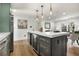 Stylish open kitchen with a large island, wine storage, and views into the adjacent living room at 151 Wilbur Ln, Lawrenceville, GA 30044