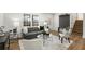 Inviting living room with comfortable seating, stylish decor, large windows, and easy access to the staircase at 151 Wilbur Ln, Lawrenceville, GA 30044