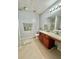 Bright bathroom with granite countertops, wood cabinets, and tiled floors offers a clean, modern design at 1552 Viero Dr, Lawrenceville, GA 30044