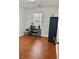 Bedroom with desk and chair, dark wood-look floor, and a sunny window view at 1552 Viero Dr, Lawrenceville, GA 30044