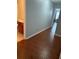 Hallway with wood-look flooring leading to the bathroom and another bedroom at 1552 Viero Dr, Lawrenceville, GA 30044