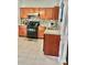 Kitchen featuring stainless steel appliances, wood cabinets and stone countertops at 1552 Viero Dr, Lawrenceville, GA 30044
