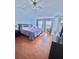 Main bedroom with a ceiling fan, hardwood floors, and multiple windows at 1552 Viero Dr, Lawrenceville, GA 30044