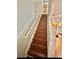 Stairway with wooden steps and white railing at 1552 Viero Dr, Lawrenceville, GA 30044
