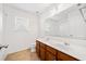 Bathroom featuring a double vanity, framed mirror, a window, and a toilet at 28 Dover Commons Dr, Tucker, GA 30084