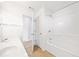 Bright bathroom with double sinks, tub, and a door to another room at 28 Dover Commons Dr, Tucker, GA 30084