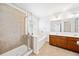 Bathroom features a glass shower, separate tub, double sink vanity with tile flooring at 28 Dover Commons Dr, Tucker, GA 30084