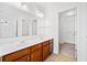 Bathroom showcases a double sink vanity, tile flooring, and a view into the walk-in closet at 28 Dover Commons Dr, Tucker, GA 30084