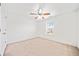 Bright bedroom with neutral carpet, a ceiling fan, and natural light from the window at 28 Dover Commons Dr, Tucker, GA 30084