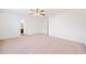 Expansive bedroom offers neutral carpet, ceiling fan, and easy access to the en-suite bathroom at 28 Dover Commons Dr, Tucker, GA 30084