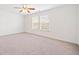 Spacious bedroom with plush carpet and large windows allowing natural light to fill the room at 28 Dover Commons Dr, Tucker, GA 30084