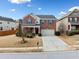Attractive two-story brick home featuring a well-maintained lawn and an attached garage at 28 Dover Commons Dr, Tucker, GA 30084