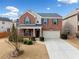 Charming two-story brick home with a manicured front yard and attached two-car garage at 28 Dover Commons Dr, Tucker, GA 30084