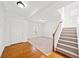 Bright foyer featuring wood floors, a staircase, and a view into the living room at 28 Dover Commons Dr, Tucker, GA 30084