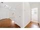 Bright hallway with hardwood floors leading to other rooms in the home at 28 Dover Commons Dr, Tucker, GA 30084