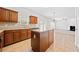 Open kitchen features an island, tile floors, and stainless steel appliances at 28 Dover Commons Dr, Tucker, GA 30084