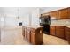 Open kitchen features an island, tile floors, and stainless steel appliances at 28 Dover Commons Dr, Tucker, GA 30084
